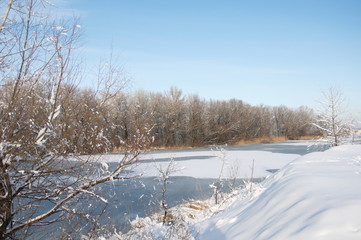 Frozen river. Winter landscape.