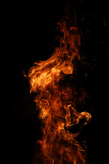 Tongues of flame of fire of orange-yellow color from burning fir © alexkich