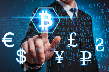 Bitcoin. A man in a suit and tie clicks the index finger on the virtual screen. Exchange crypto...