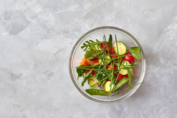 Salad from raw vegetables in a glass plate