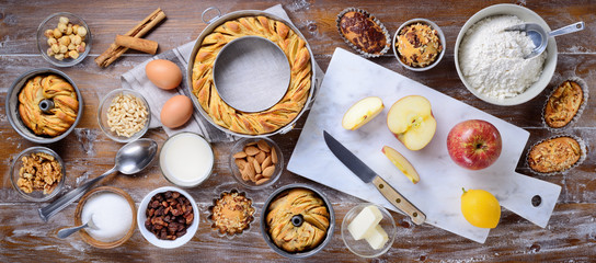 Cakes, apple donuts, muffins, pastries and ingredients. Top view
