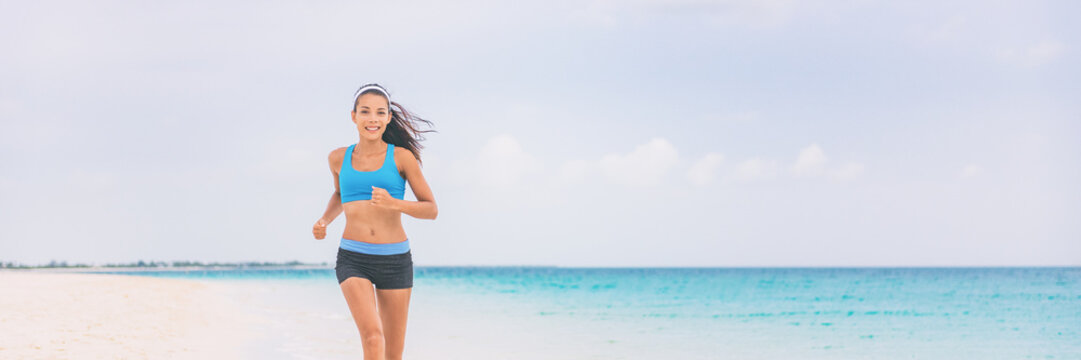 Healthy running girl jogging on beach training cardio. Exercise outside in summer background panorama banner. Asian woman happy morning motivation. Active people lifestyle.