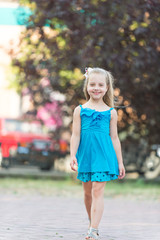 Child smiling with long blond hair