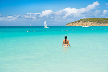 sensual girl in sexy bikini on sea beach in antigua