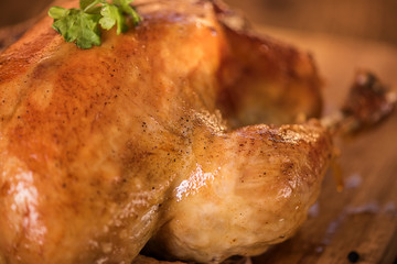 fresh roast chicken with stuffing on wood background close up 