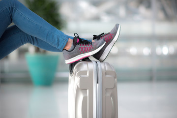 passenger leg on luggage at airport