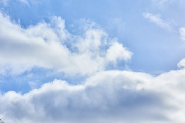 light cumulus clouds in the blue sky