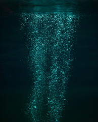 Close up of air bubbles in the water on dark background