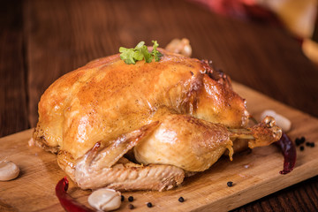 fresh roast chicken with stuffing on wood background close up 