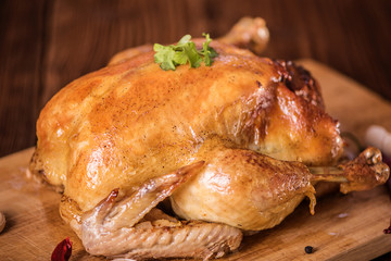 fresh roast chicken with stuffing on wood background close up 