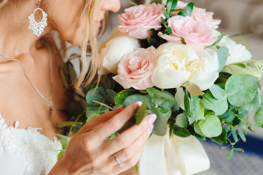 Close up macro shot of bride holding beautiful tender wedding bouqet of wonderful flowers in her hands