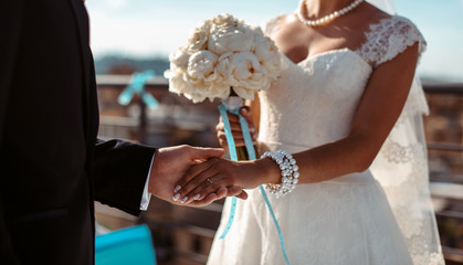 Wedding couple holding hands with love and tenderness. Wedding rings. Man giving an engagement ring...