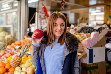 Caucasian young woman holding apple