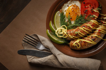 Fried sausages with spices, vegetables and greens.