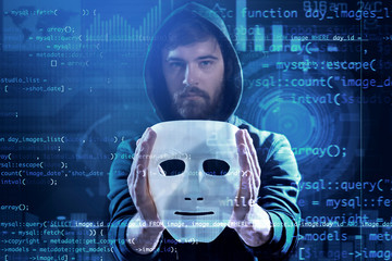 Hacker with mask in darkness