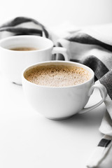 Cappuccino on a striped tablecloth. Morning coffee.