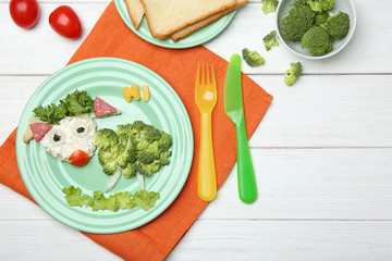 Creative breakfast for children on wooden background, top view