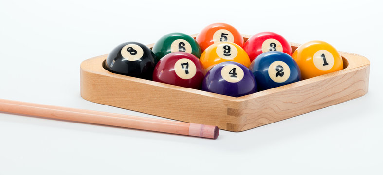 Pool cue and nine ball rack of balls ready for a billiards game