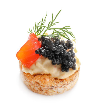 Delicious canape with black caviar on white background