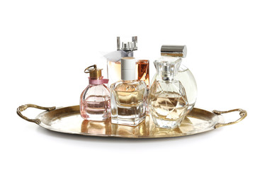 Metal tray with perfume bottles on white background