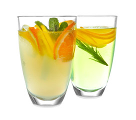 Glasses of fresh lemonade on white background