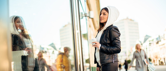 Beautiful woman with coffee and credit card