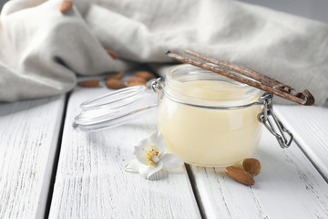 Jar with tasty vanilla pudding on table