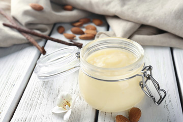 Jar with tasty vanilla pudding on table