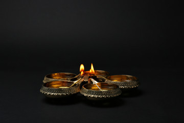 Diwali diyas or clay lamps on dark background