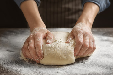 Woman kneading dough on table, closeup - Powered by Adobe