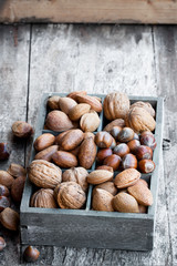 Various  nuts in wooden box on rustic table