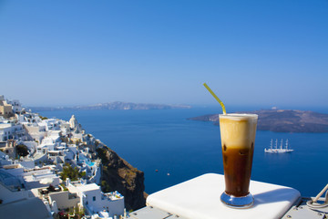 Greece Santorini island in Cyclades, coffee espresso freddo with wide sea of caldera in greek caffe