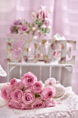 romantic pink rose bouquet lying on the bed