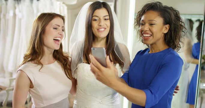 4k, Young women taking pictures with friends at a bridal store. Slow motion.