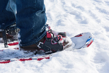 Closeup of man heading out in the snow to snowshoe