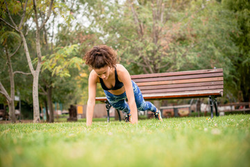 Young woman doing push-ups