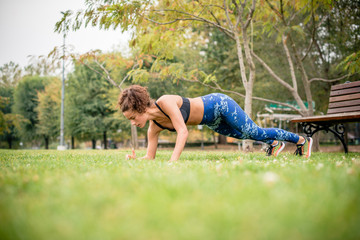 Side view of woman doing push-ups