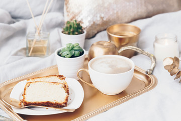 Morning composition with coffee on tray. Glamour breakfast in bed