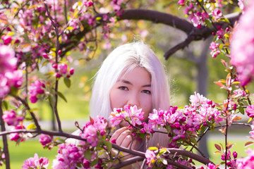 Fototapeta premium Gorgeous Kazakh lady and blossoming tree