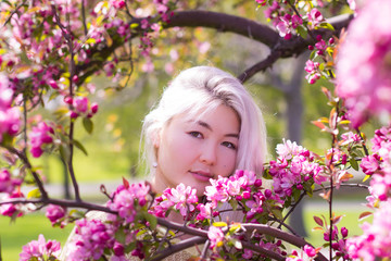 Gorgeous Kazakh lady and blossoming tree