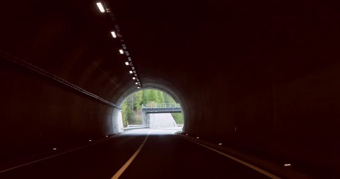 Driving in a Tunnel, Cinema 4k pov view of a road through tunnel and in a fall color alpine landscape, on the top of simplon pass, on a sunny autumn day, in Valais, Switzerland