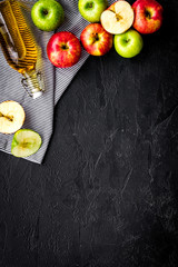 Bottle of fresh cider near autumn apples. Black background top view space for text
