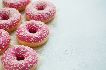 Donut. Sweet icing sugar food. Dessert colorful snack. Glazed sprinkles. Treat from delicious pastry breakfast. Bakery cake. Doughnut with frosting. Baked unhealthy round. Top view with copy space