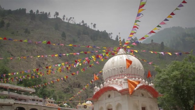 Temple situated in a lower Himalaya is decorated with colourful pennants or prayer flags, Manikaran, Himachal pradesh, India (2017)