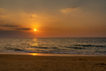 Beautiful scene of sunset with cloudscape over the sea beach