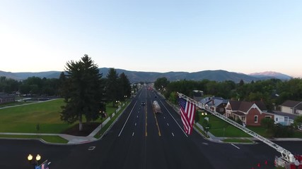 Aerial above the American flag being flown on a firetruck. 
