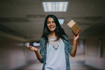 A young Indian Asian woman tries VR (Virtual Reality) goggles for the first time and is surprised...