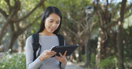 Fototapeta premium Young Woman use of tablet computer at outdoor
