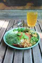 Thai Noodles (Kanom jeen) in a green dish.