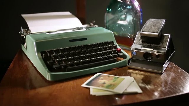 Man put polaroids on desk and start writting letter.